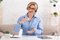 Modern remote work. Friendly woman with headset explains to client