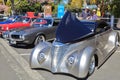 A modern replica of a 1937 Ford Coupe at a classic car show