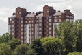 Modern residential apartment building among green trees. Property in ecological quiet area concept. Royalty Free Stock Photo