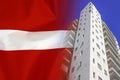 Modern residential building on background of flag Latvia