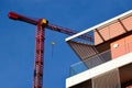 Modern building roof parapet detail. tower crane in a distance. consruction concept.