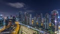 Modern residential and office complex with many towers aerial night timelapse at Business Bay, Dubai, UAE. Royalty Free Stock Photo