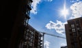 Modern residential skyscraper and beautiful blue sky and bright white clouds. White clouds on vibrant blue sky over a skyscraper. Royalty Free Stock Photo