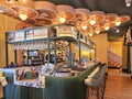 Modern restaurant and bar interior with decorative wooden ceiling at Malaga Old Town