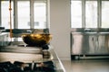 Within a modern restaurant's professional kitchen a shiny metal bowl is Royalty Free Stock Photo