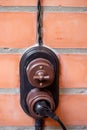 Modern retro switch and socket with twisted wire on a brick wall background Royalty Free Stock Photo