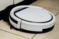 Modern robot vacuum cleaner is charged with electricity Royalty Free Stock Photo