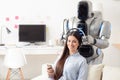 Modern robot wearing headphones on smiling girl