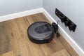 A modern robotic vacuum cleaner that charges in a docking station, an autonomous cleaning robot.