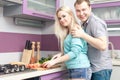 Modern romantic couple preparing meal at home