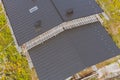 dark gray roof of an industrial building made of metal. Corrugat