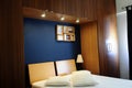 Modern Room with Dark Navy Blue Wall and Wooden Wardrobe Royalty Free Stock Photo