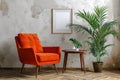 modern room interior with blank white picture frame, bright orange armchair, coffee table and house plant against a gray wall Royalty Free Stock Photo