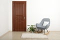 Modern room interior with brown door and rocking chair