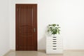 Modern room interior with small cabinet and closed door. Royalty Free Stock Photo