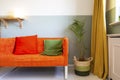 Modern room with yellow curtains and orange sofa, colorful Scandinavian design Royalty Free Stock Photo