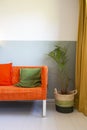 Modern room with yellow curtains and orange sofa, colorful Scandinavian design Royalty Free Stock Photo