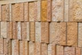 Modern rough textured limestone wall background with vertical aligned stone bricks