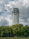 Modern round high-rise building on a green hill. Khimki District, Moscow