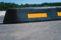 Modern rubber barrier for cars in summer parking. Close-up. Royalty Free Stock Photo