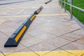 Modern rubber barrier for cars in summer parking in the street Royalty Free Stock Photo