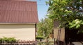 modern rural authentic house with siding and outbuildings in the backyard, the concept of summer life in the countryside