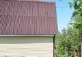 Modern rural authentic house with siding and outbuildings in the backyard, the concept of summer life in the countryside