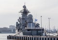 Modern Russian military cruiser battleship on the pierce. Russian Navy Ensign on the ship board. Russia, Vladivostok Royalty Free Stock Photo