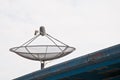 Modern satellite dish on the roof top in cloudy day