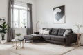 Modern scandinavian home interior of living room with design gray sofa, armchair, marble stool, black coffee table, stylish painti