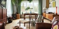 Modern scandinavian home interior of living room with design retro furniture, tropical plant, window, decoration and elegant.