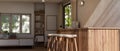 A modern Scandinavian home kitchen with a wooden kitchen island or counter, stools, and accessories