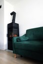 Modern scandinavian living room with green sofa and a modern freestanding contemporary fireplace Royalty Free Stock Photo