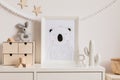 The modern scandinavian newborn baby room with mock up frame, wooden toy, plush toys, decor, children accessories.