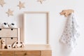 The modern scandinavian newborn baby room with mock up frame, wooden toy, plush toys, decor, children accessories.