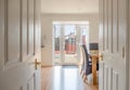 Modern Scottish Kitchen Dinning Room with Oak table and Chairs  in clean White Painted Coloirs looking onto the Patio doors Royalty Free Stock Photo