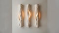 Modern sculptural wall lights with warm illumination. Artistic interior lighting design