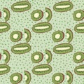 Modern seamless pattern with abstract kiwi fruit slices silhouettes. Pastel background with dots