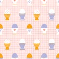 Modern seamless pattern of Easter eggs in eggcups with various ornaments on a pink checkered background. Royalty Free Stock Photo
