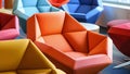 A modern seating area featuring colorful geometricshaped chairs that offer ergonomic support and feature builtin