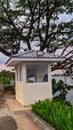 Modern Security Guard Post Under a Large Tree Near the Water\'s Edge Royalty Free Stock Photo
