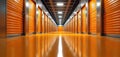 Modern self storage facility corridor features many orange roller shutter units. Gleaming polished reflective floor, bright Royalty Free Stock Photo