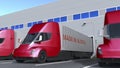 Modern semi-trailer trucks with MADE IN AUSTRIA text being loaded or unloaded at warehouse. Venezuelan business related