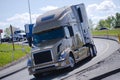 Modern semi truck reefer trailer on semicircular turn exit highway