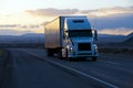 Modern semi truck trailer on twilight highway