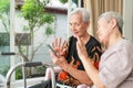 Modern senior grandmother using mobile phone,looking at cell phone screen,Waving her hands,Say Hi,talking to family while online Royalty Free Stock Photo