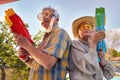 Modern Senior couple have fun playing with  water gun Royalty Free Stock Photo