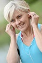 Modern senior woman listening to music ready for jogging Royalty Free Stock Photo