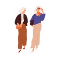 Modern senior women friends walking and talking together. Fashion elegant elderly gray-haired ladies strolling in