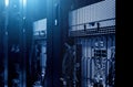 Modern server rack cluster under meshed door in big data centre with blue neon toning. Close up. Internet provider